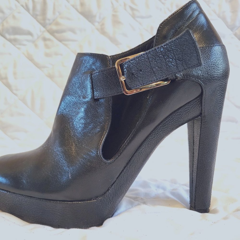 Buckle accented boots by Dior